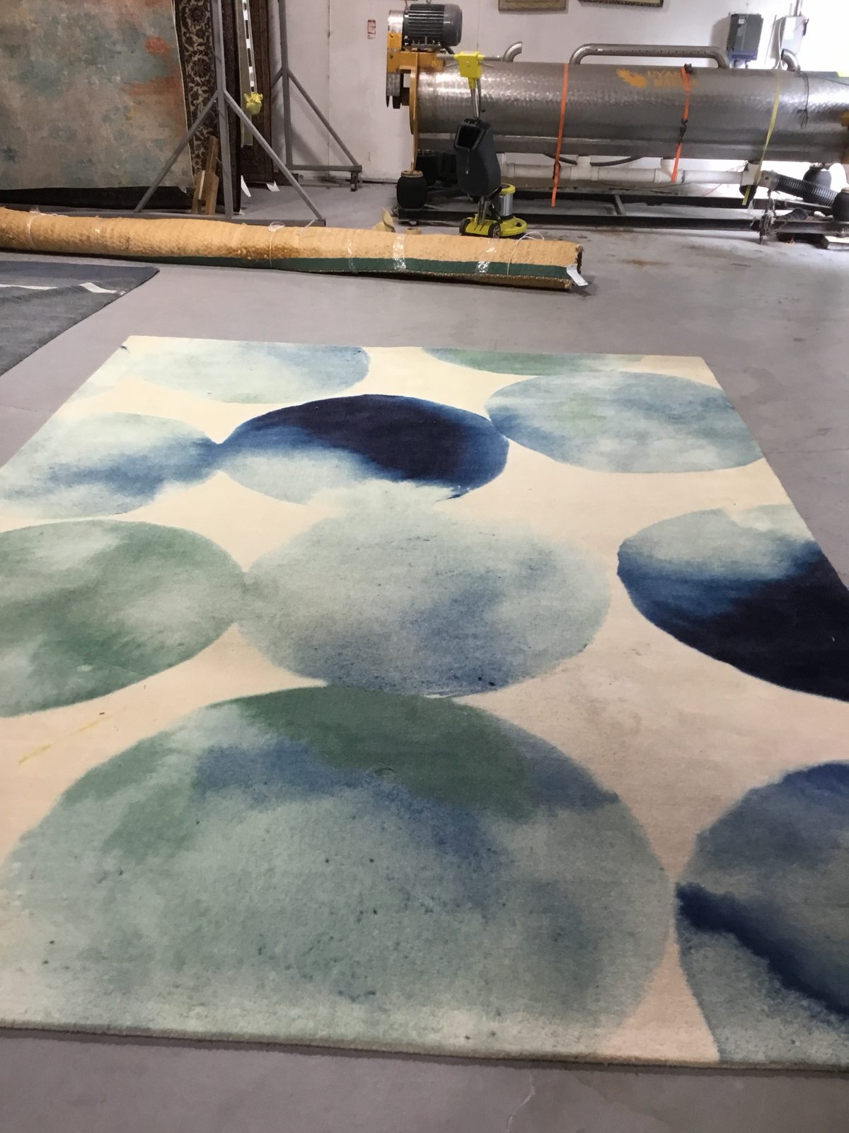Modern watercolor circle wool rug with dull ivory field before cleaning