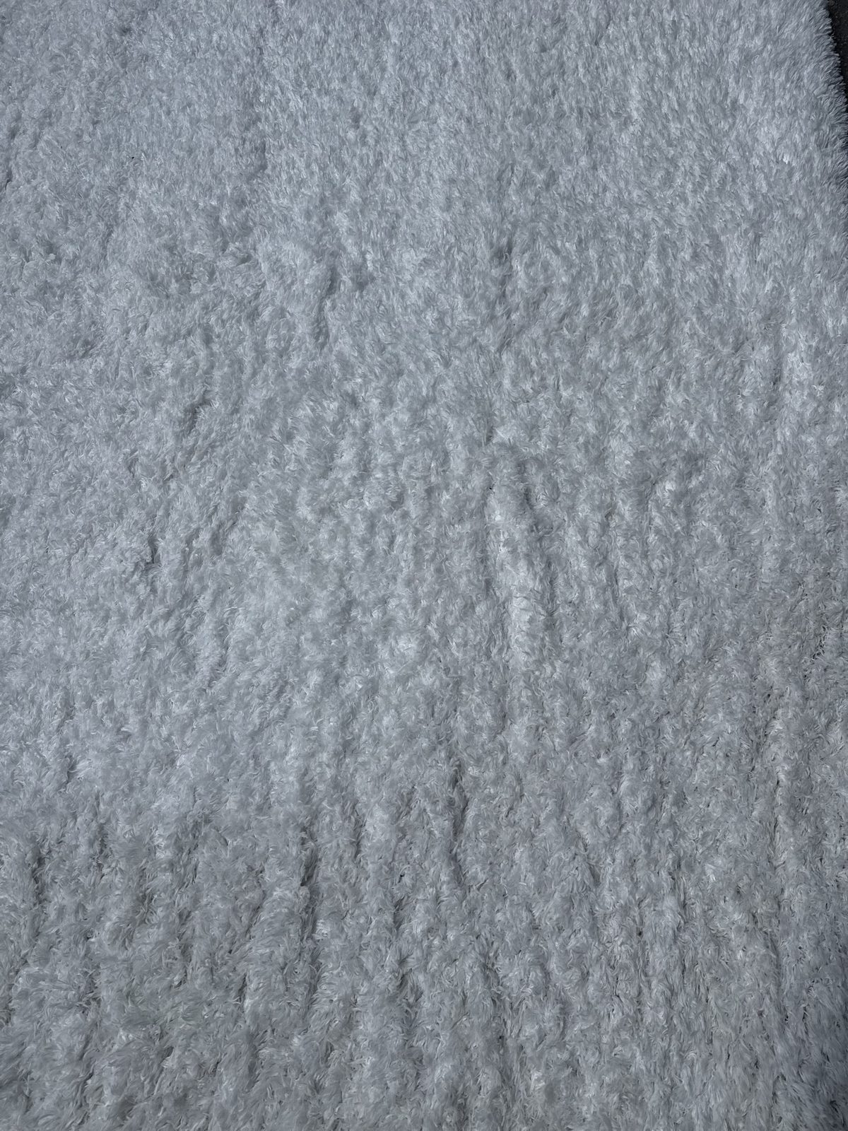 Close-up of restored white shag pile after rug cleaning